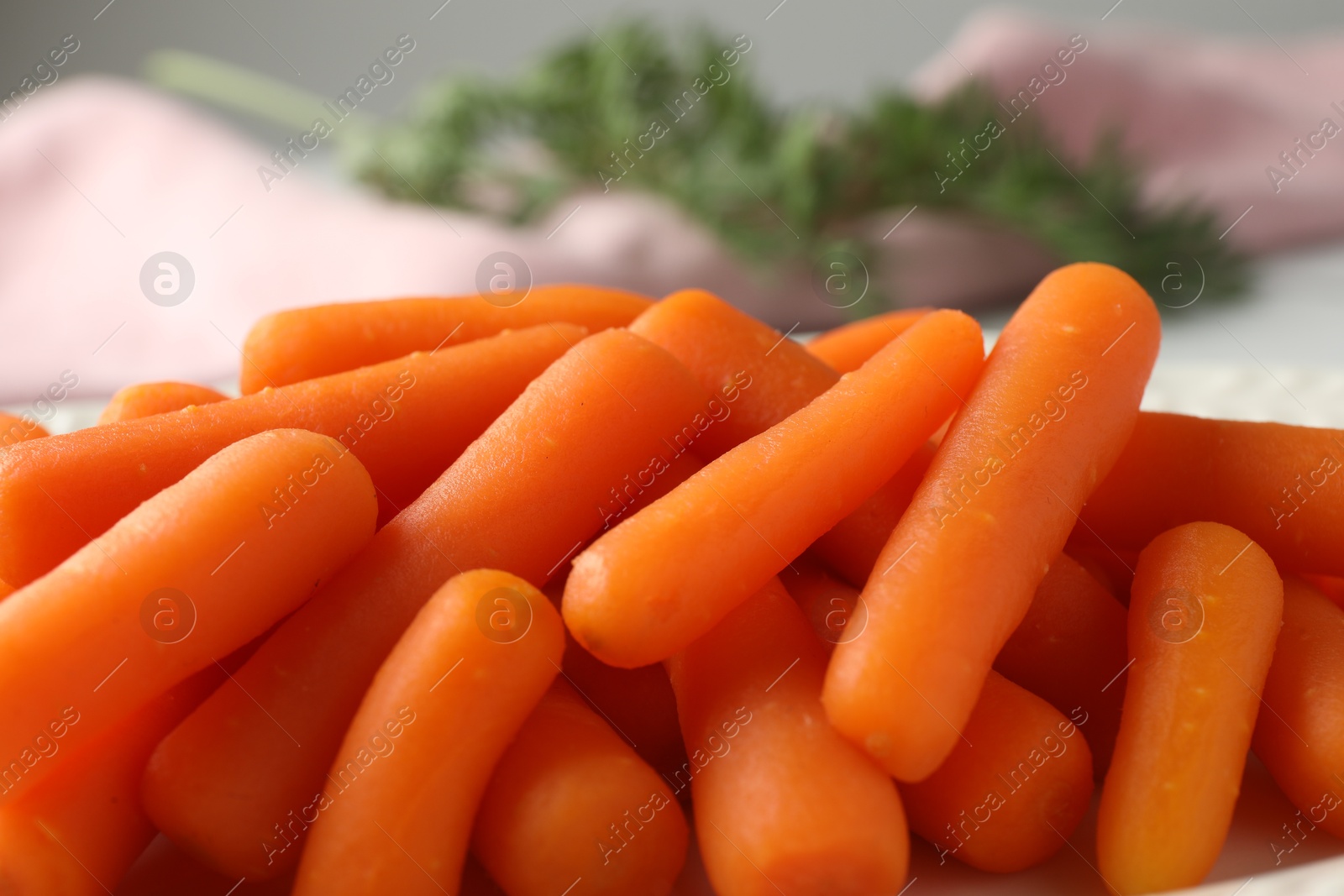 Photo of Pile of baby carrots on table, closeup