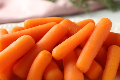 Pile of baby carrots on table, closeup