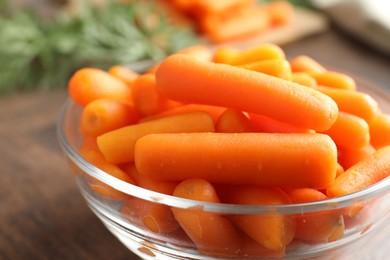 Baby carrots in bowl on table, closeup