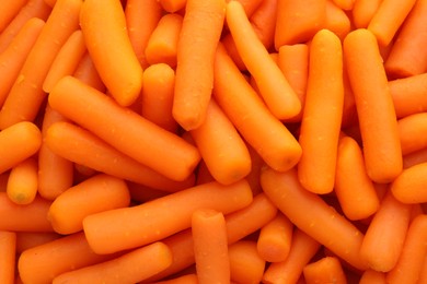 Photo of Many baby carrots as background, top view