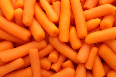 Photo of Many baby carrots as background, top view