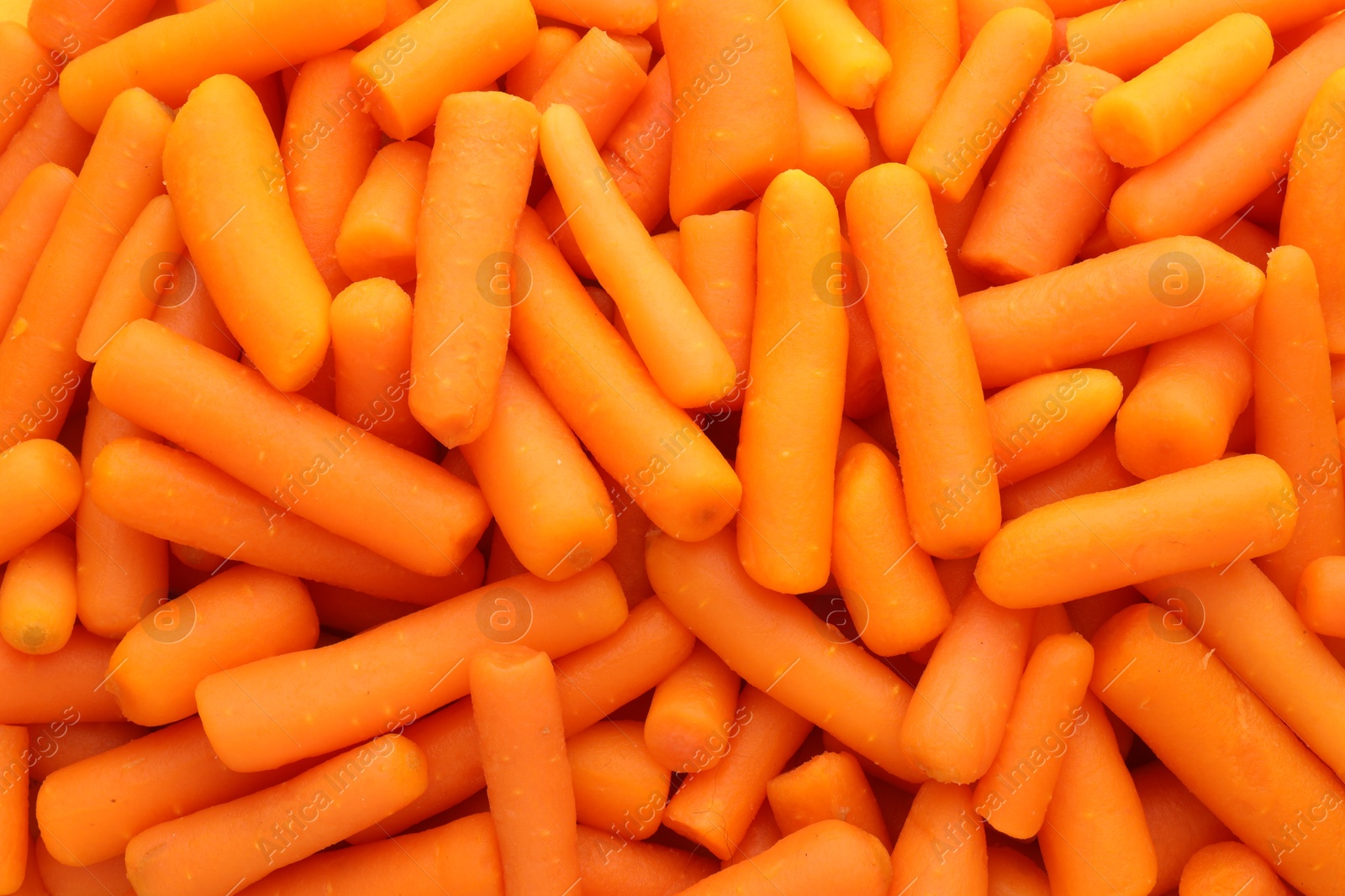 Photo of Many baby carrots as background, top view