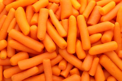 Many baby carrots as background, top view