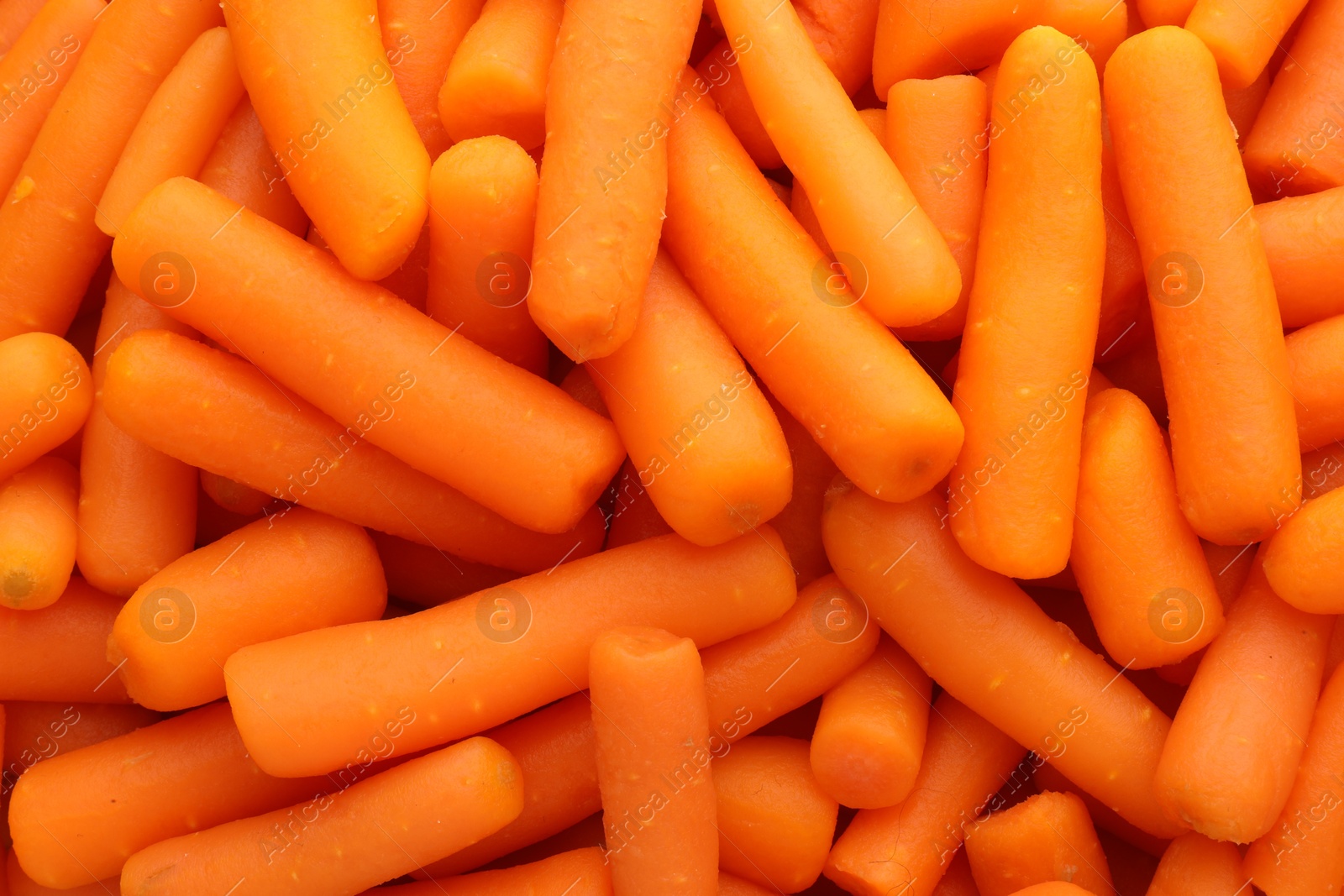 Photo of Many baby carrots as background, top view