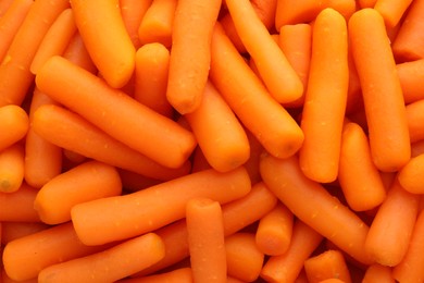 Many baby carrots as background, top view