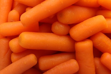 Photo of Many baby carrots as background, top view