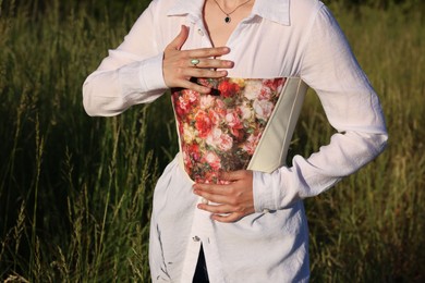 Photo of Woman in stylish corset posing outdoors, closeup