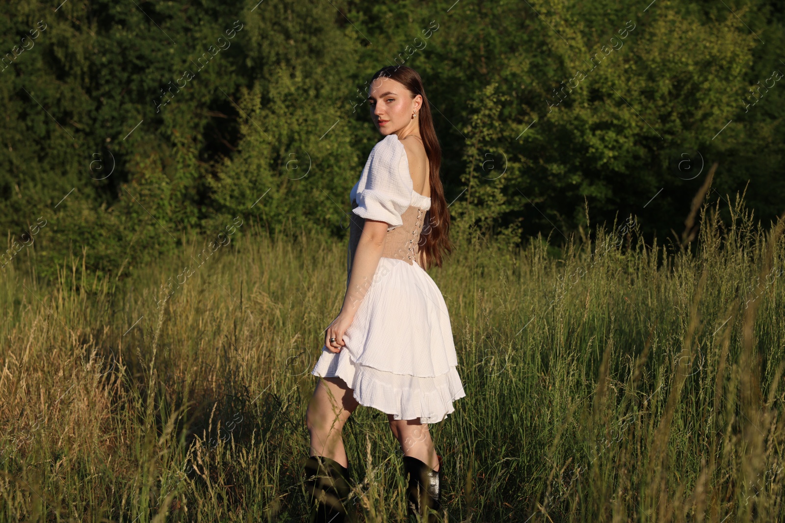 Photo of Beautiful woman in stylish corset posing outdoors