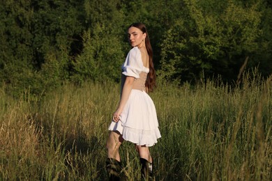 Beautiful woman in stylish corset posing outdoors