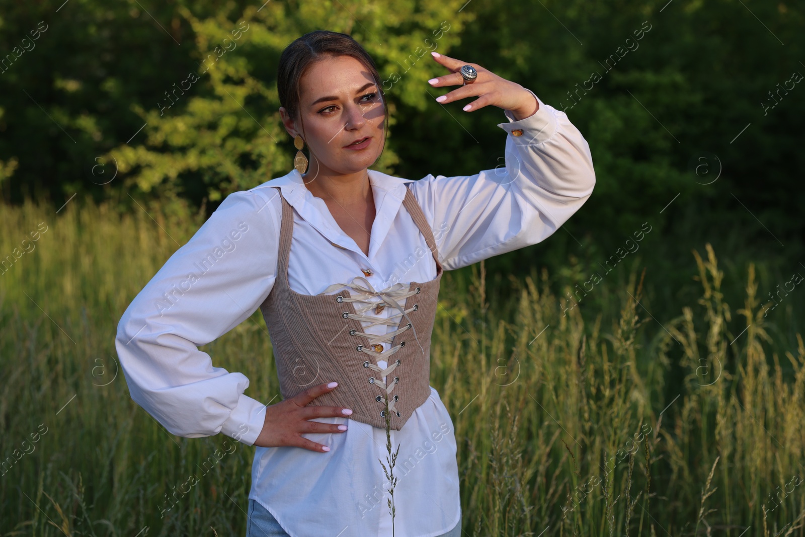Photo of Beautiful woman in velvet corset posing outdoors
