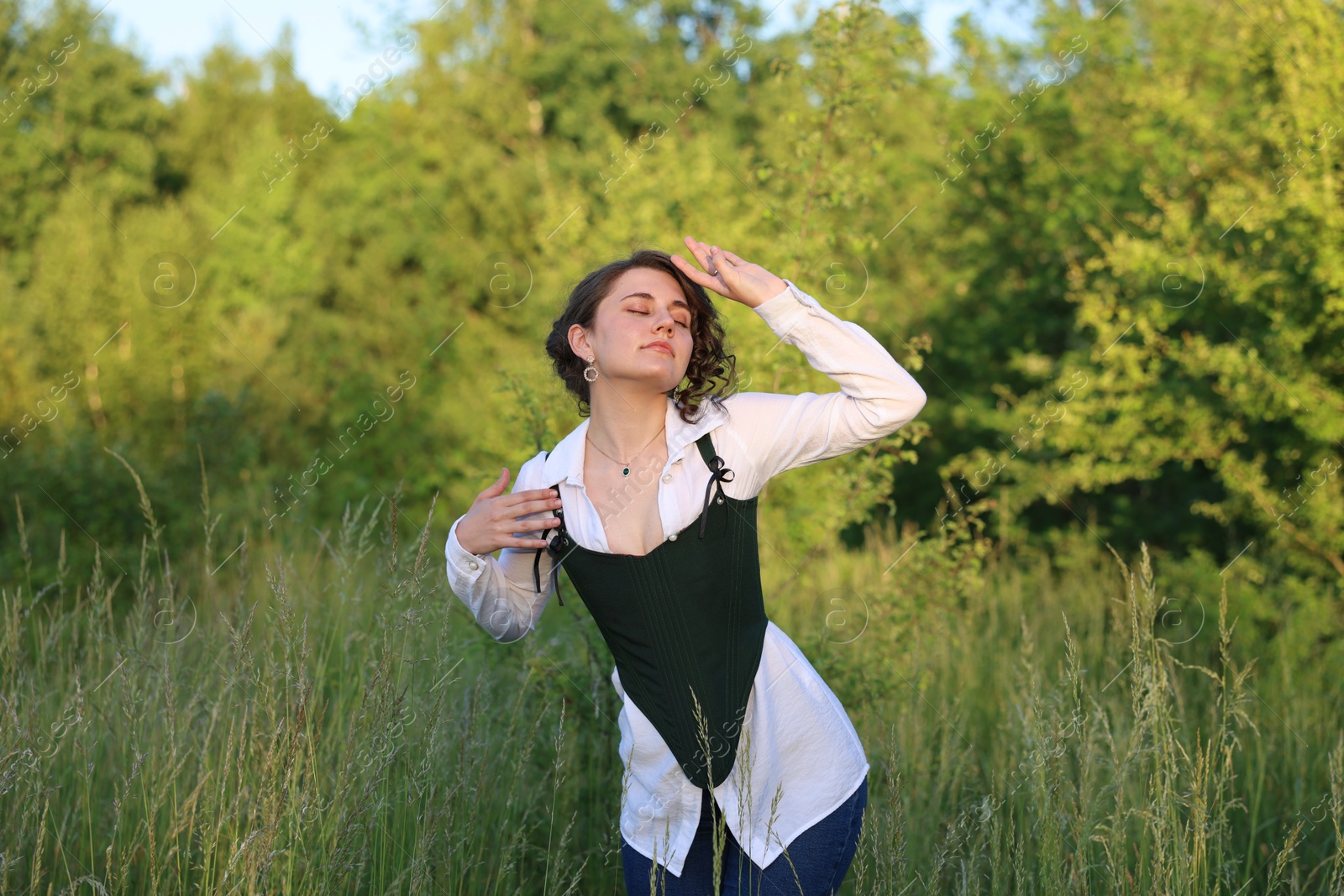 Photo of Beautiful woman in black corset posing outdoors