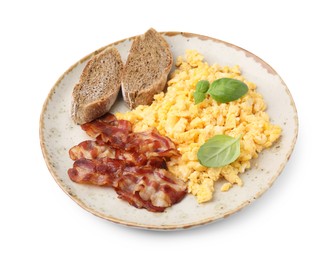 Delicious scrambled eggs with bacon and basil in plate isolated on white