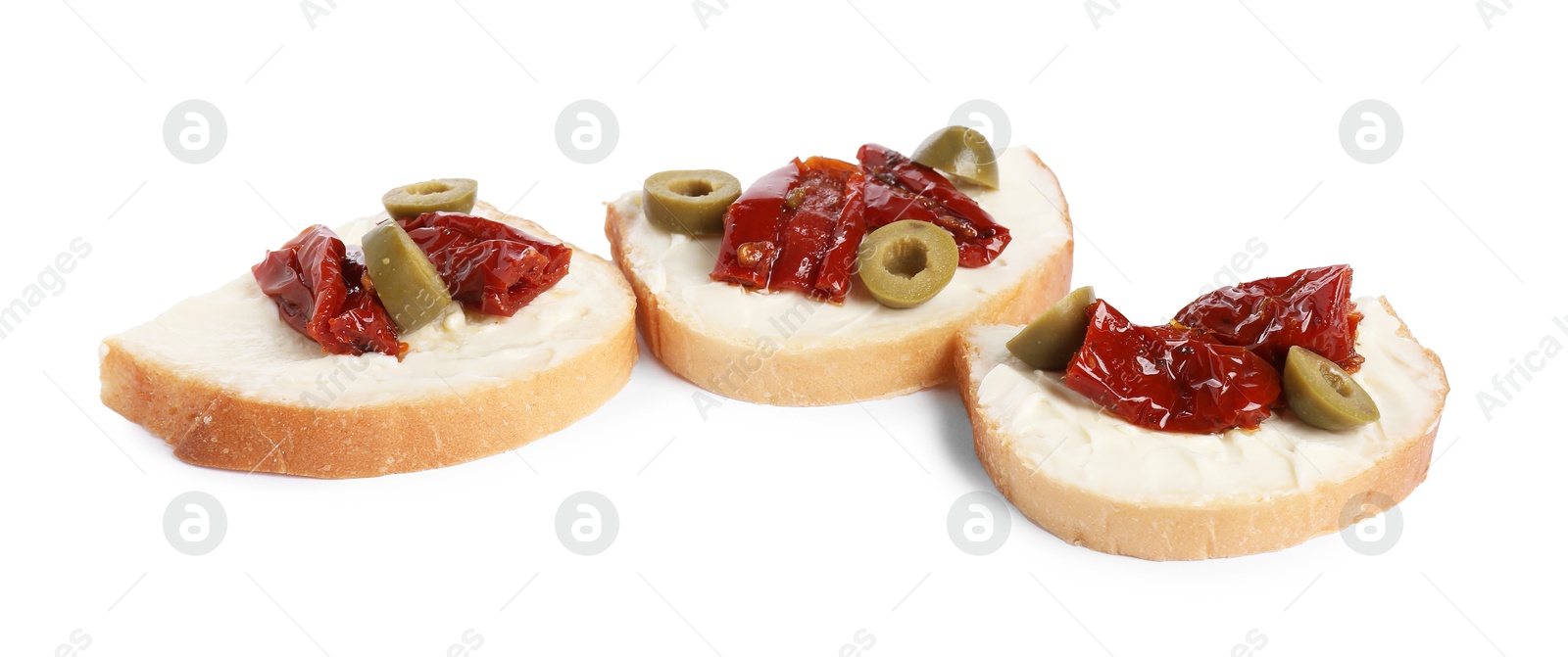 Photo of Delicious bruschettas with ricotta cheese, sun dried tomatoes and olives isolated on white