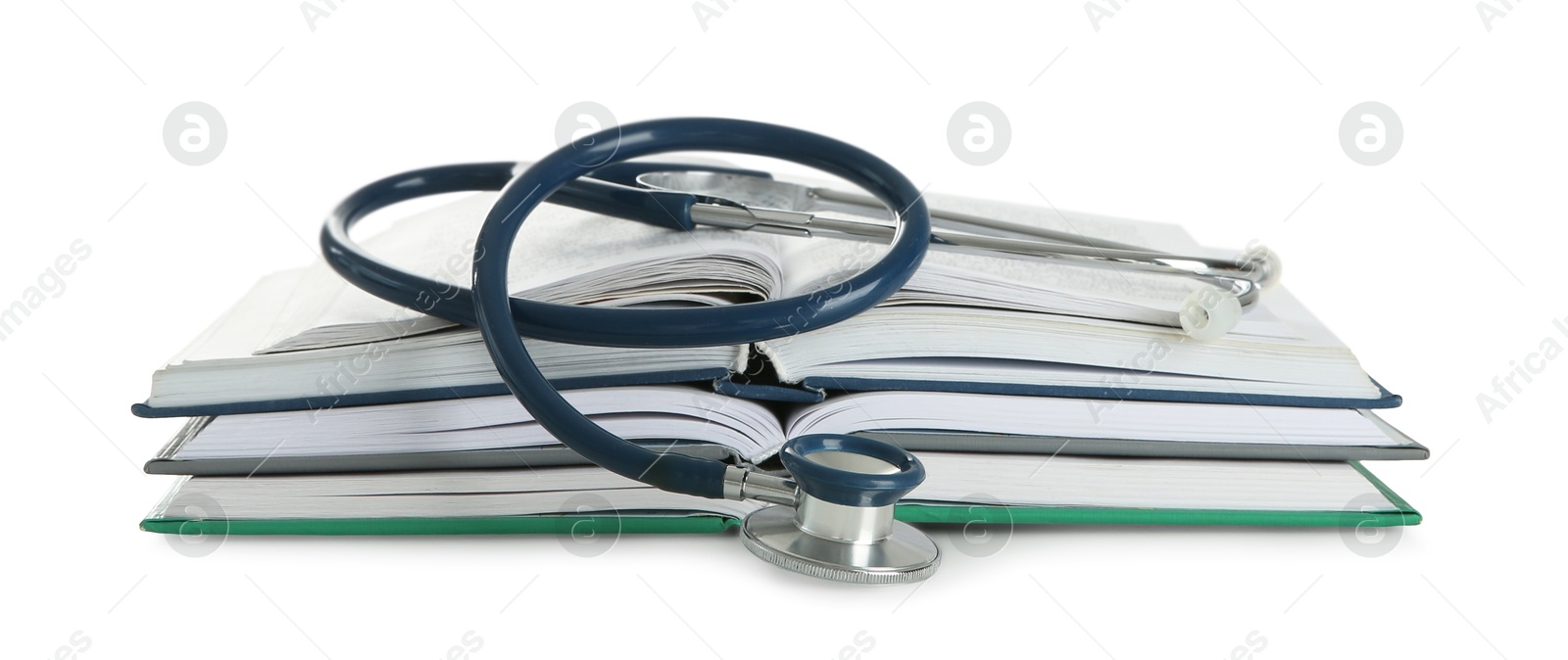 Photo of One new medical stethoscope and books isolated on white