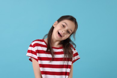 Portrait of emotional girl on light blue background