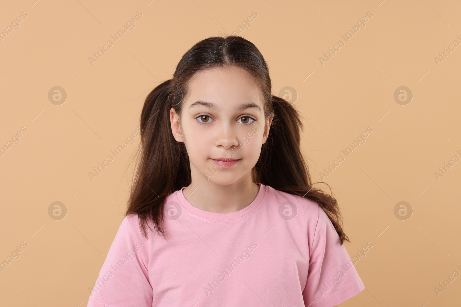 Photo of Portrait of beautiful girl on beige background