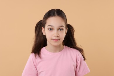 Photo of Portrait of beautiful girl on beige background