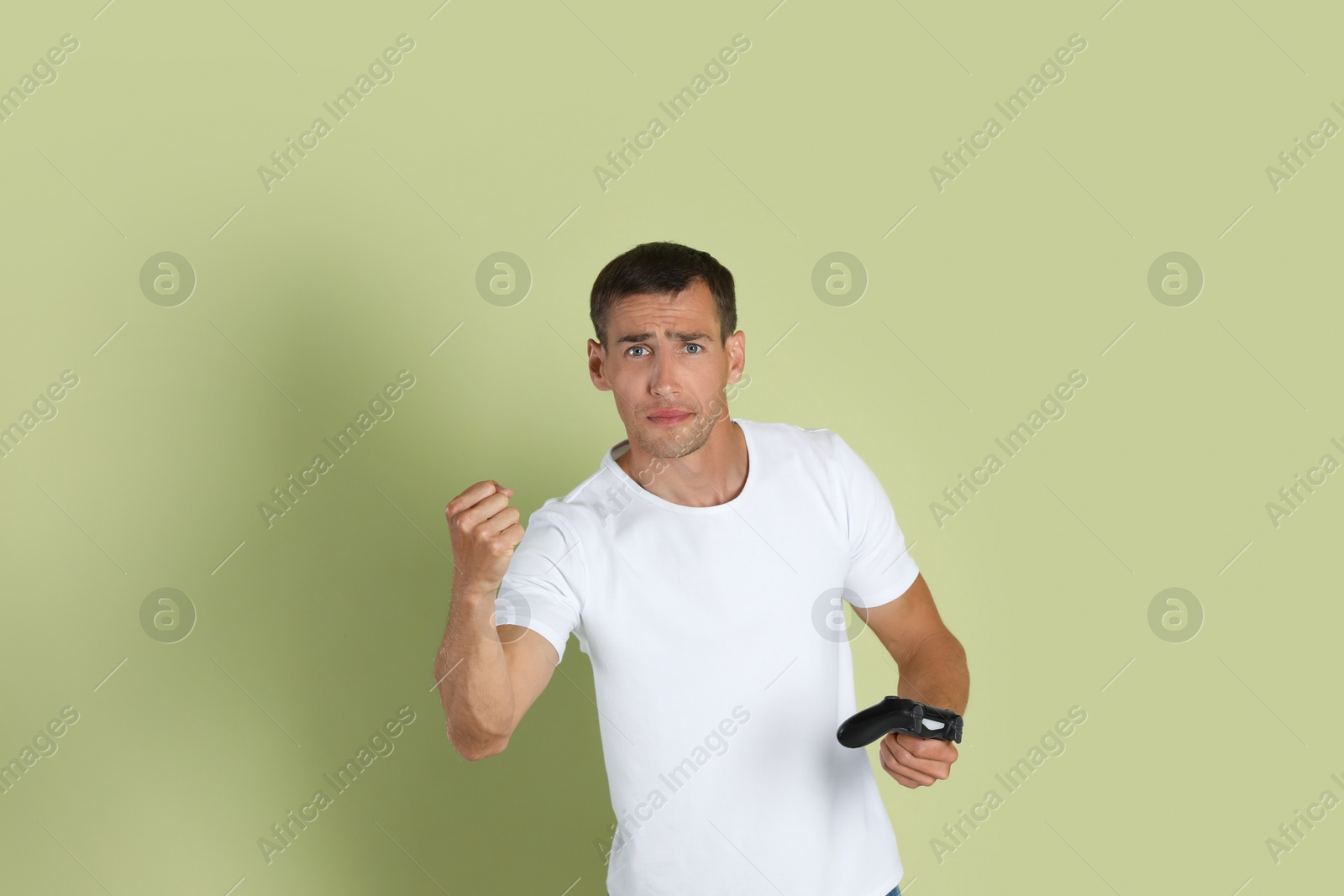 Photo of Man with controller on light green background