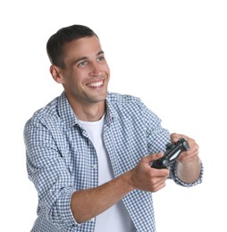 Happy man playing video games with controller on white background