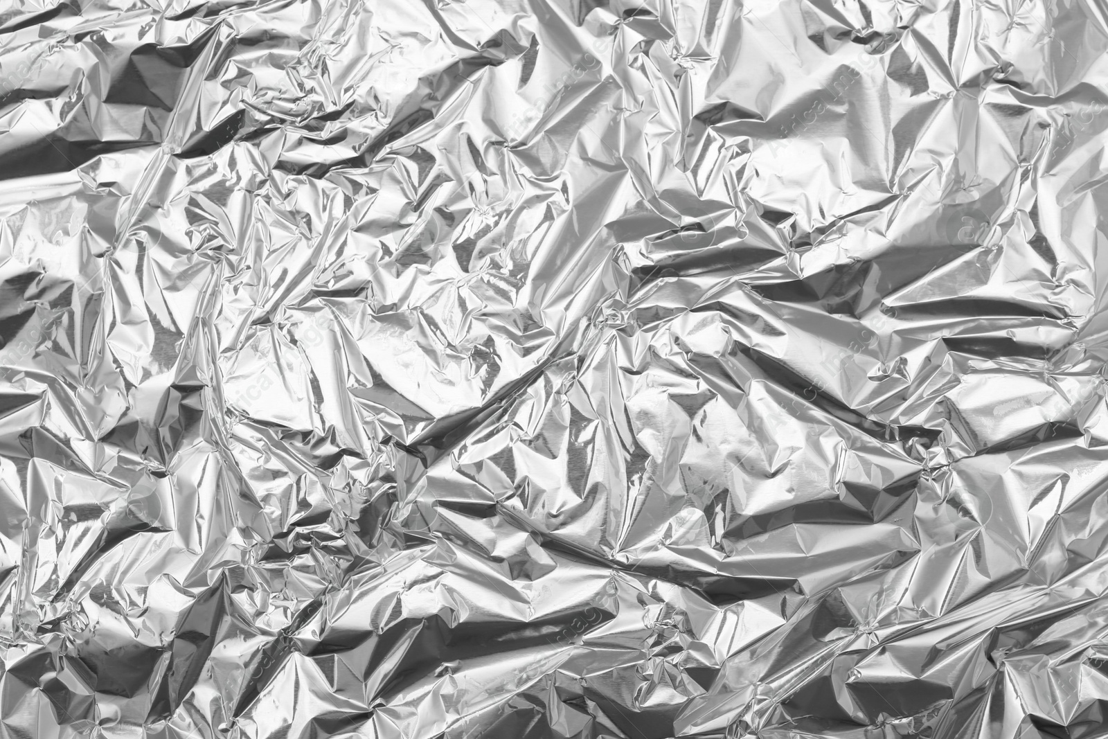 Photo of Crumpled silver foil as background, top view