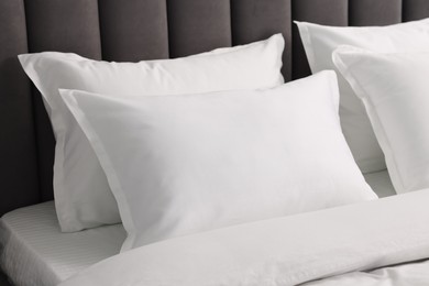 Photo of Many soft pillows on bed at home, closeup