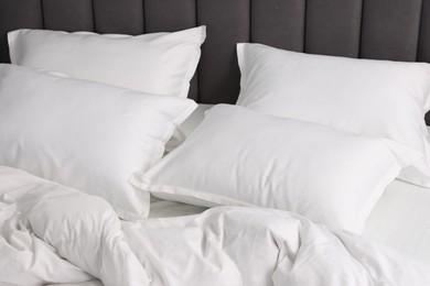 Many soft pillows on bed at home, closeup