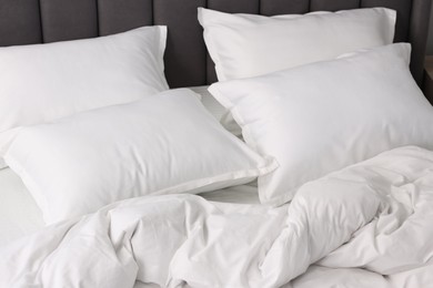 Many soft pillows on bed at home, closeup