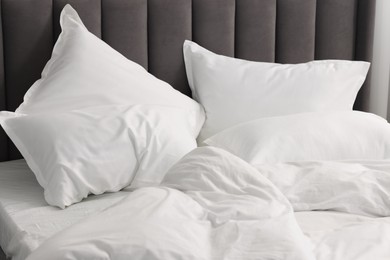 Many soft pillows on bed at home, closeup