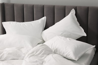 Many soft pillows on bed at home