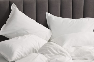 Many soft pillows on bed at home, closeup