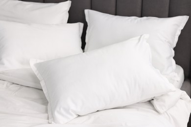 Many soft pillows on bed at home, closeup