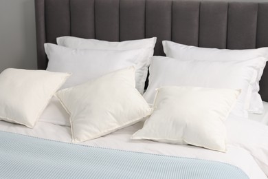 Many soft pillows on bed at home