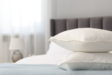 Many soft pillows on bed at home