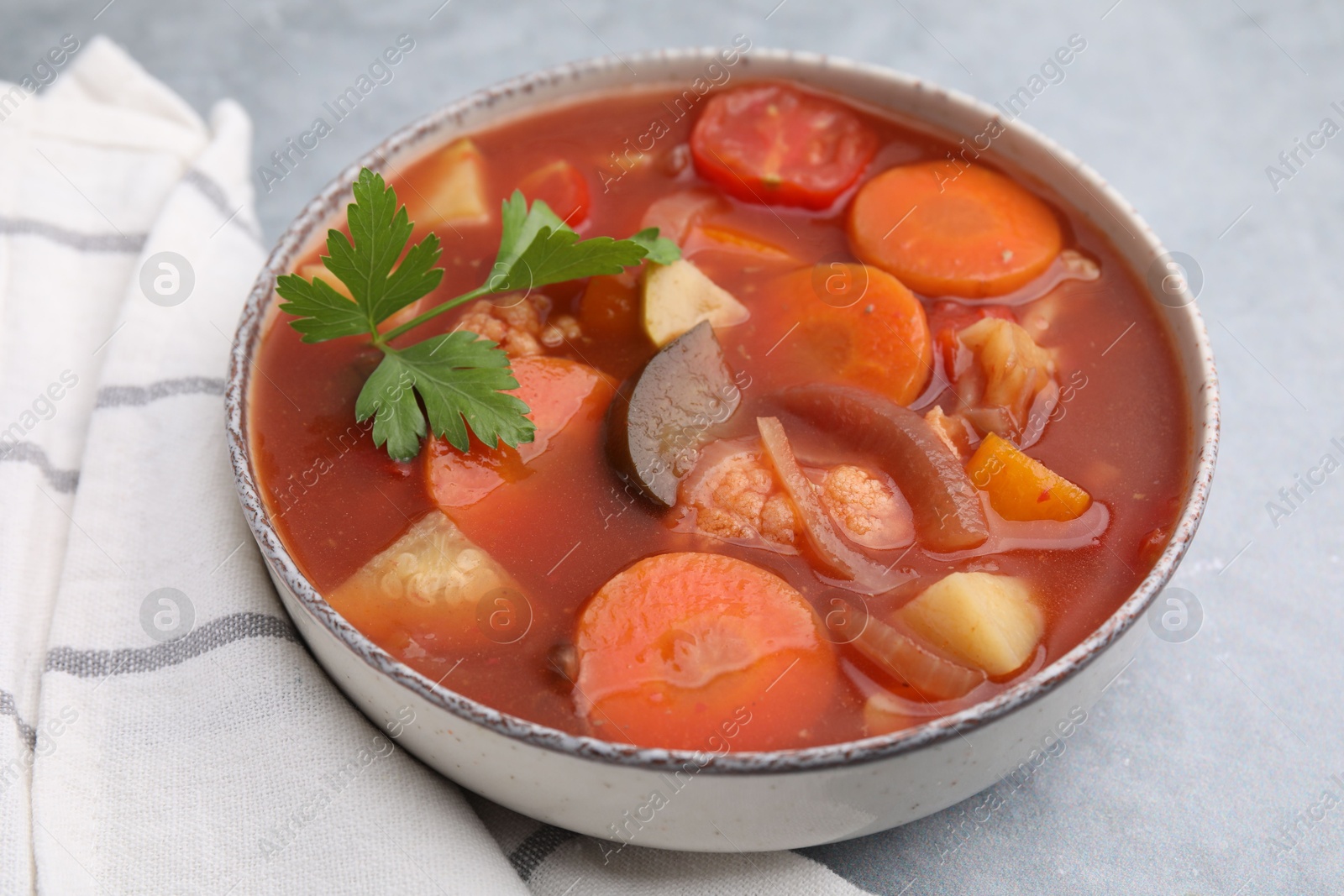 Photo of Delicious homemade stew in bowl on light table, closeup