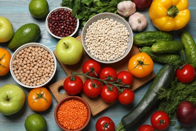 Photo of Different vegetarian products on light blue wooden table, top view