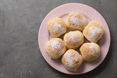 Photo of Delicious dough balls on grey table, top view. Space for text