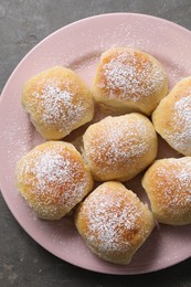 Photo of Delicious dough balls on grey table, top view