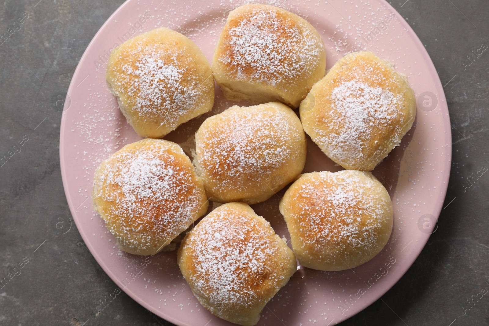 Photo of Delicious dough balls on grey table, top view