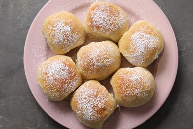 Delicious dough balls on grey table, top view