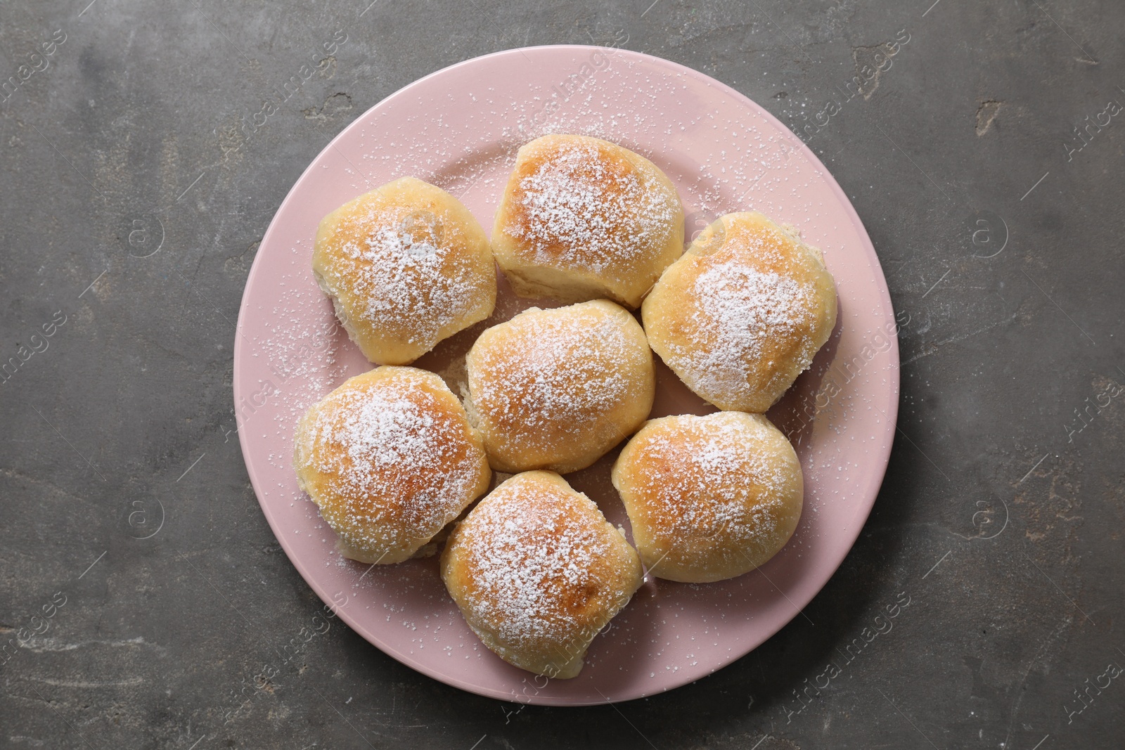 Photo of Delicious dough balls on grey table, top view