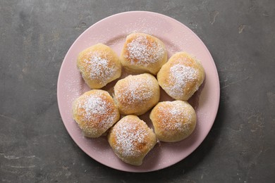 Delicious dough balls on grey table, top view