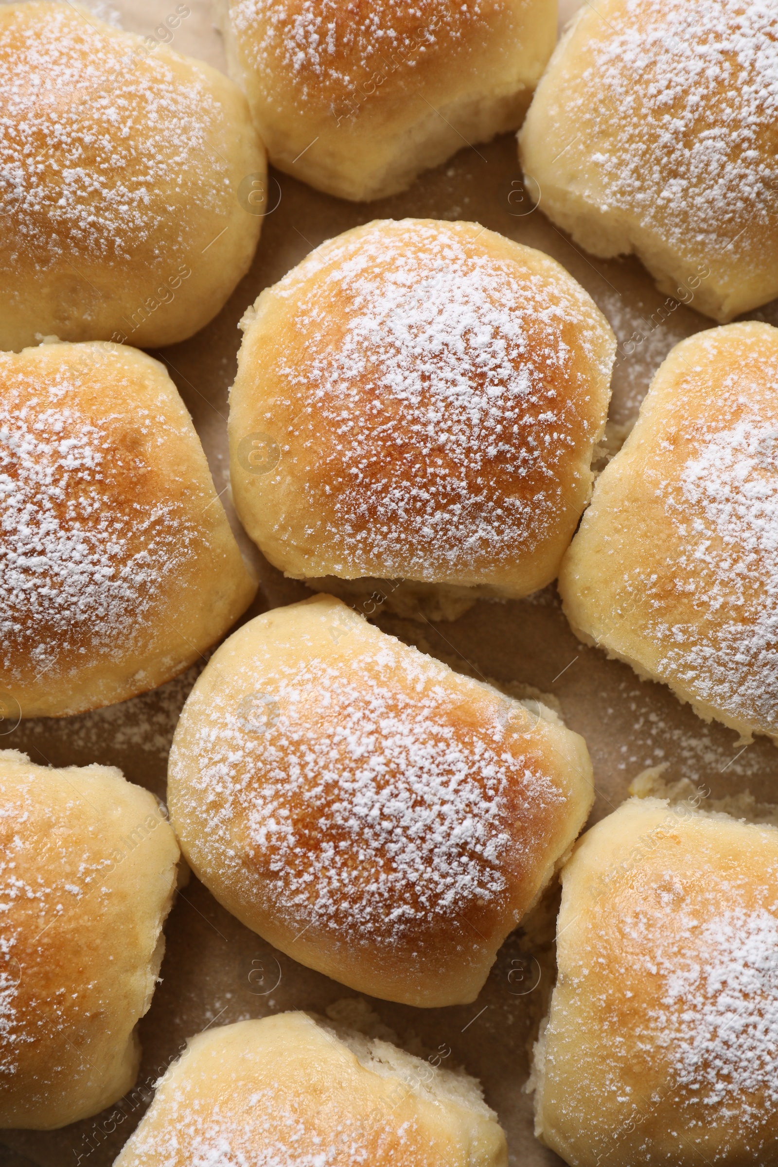 Photo of Delicious dough balls on parchment paper, top view