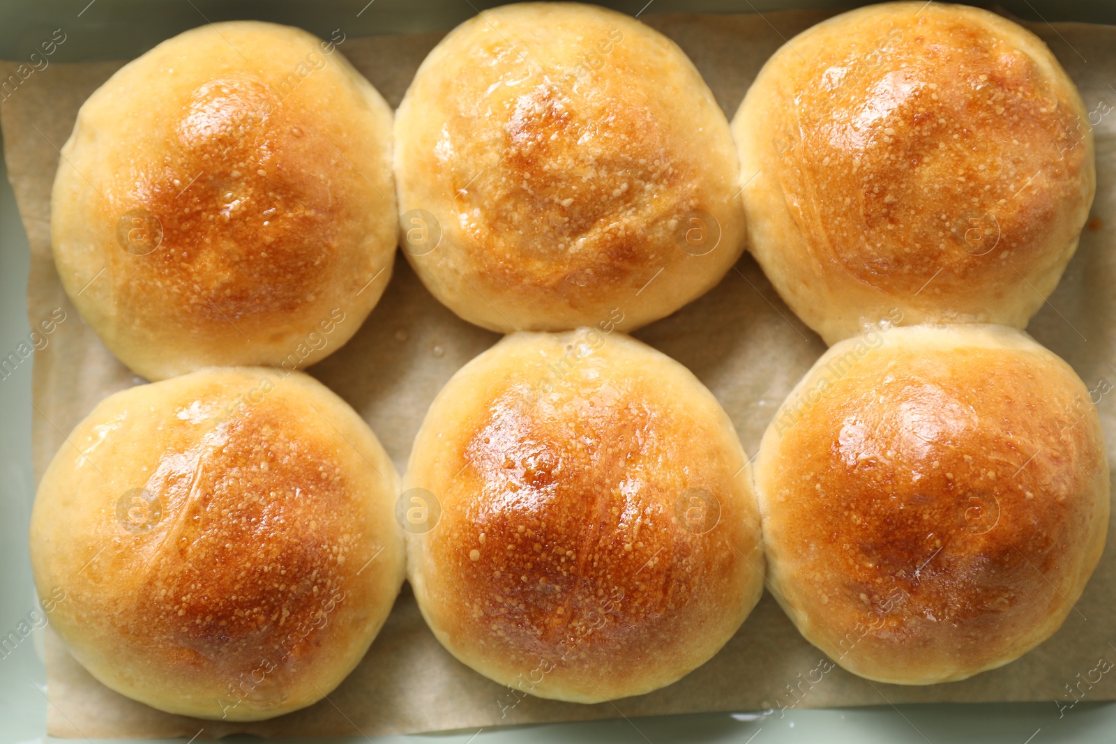 Photo of Delicious dough balls in baking dish, top view