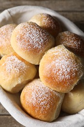 Photo of Delicious dough balls in basket on table, closeup