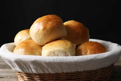 Delicious dough balls in basket on table, closeup