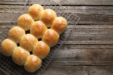 Delicious dough balls on wooden table, top view. Space for text