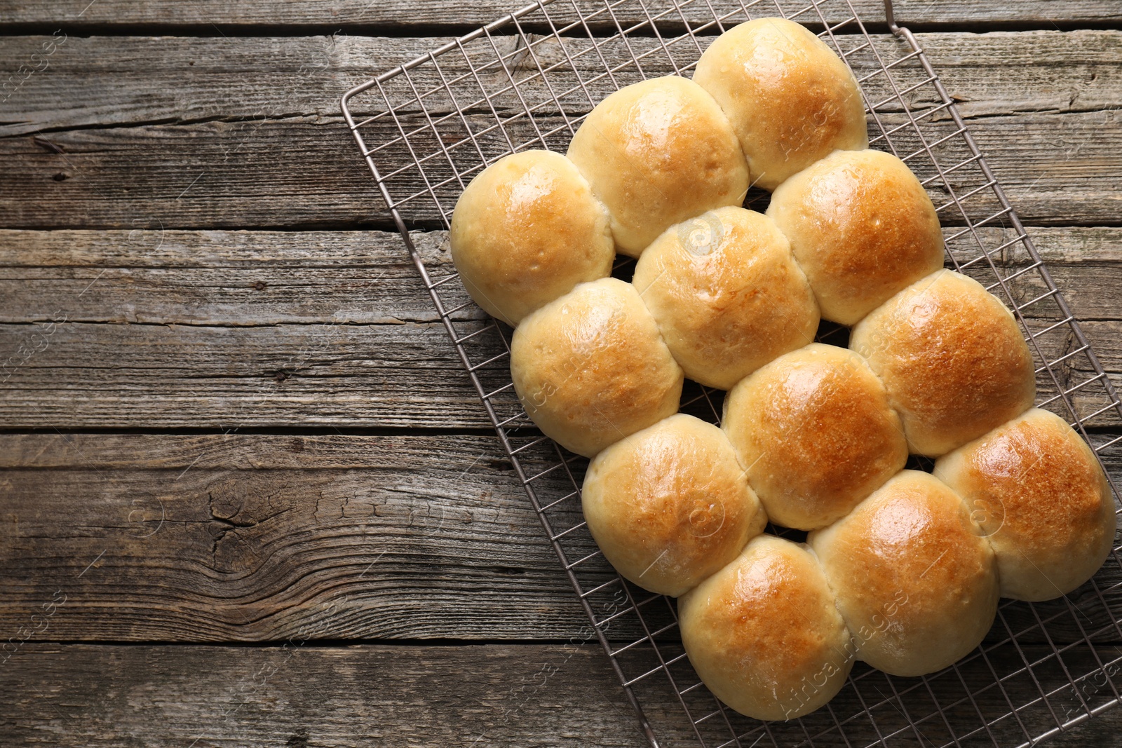 Photo of Delicious dough balls on wooden table, top view. Space for text