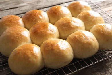 Photo of Many delicious dough balls on wooden table