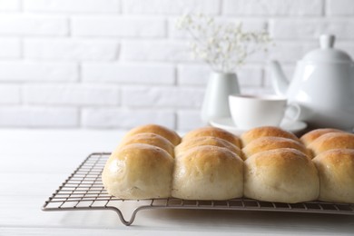 Photo of Delicious dough balls on white wooden table