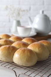 Many delicious dough balls on white table